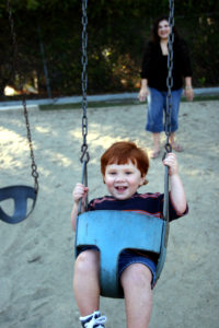 little boy swinging