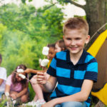 Boy camping with other kids