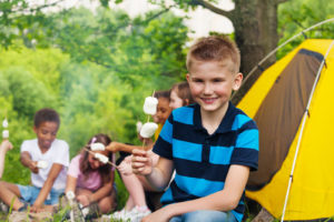 Boy camping with other kids